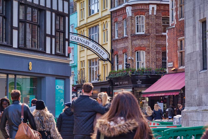 Crowds heading into Carnaby Street, London, England.