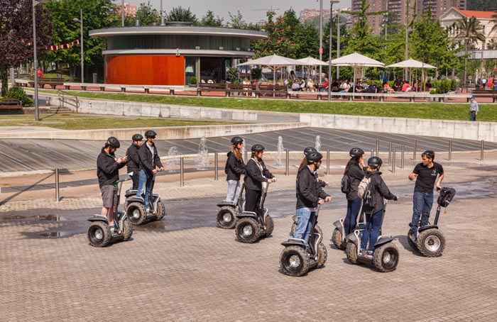 Group riding Segway scooters and receiving instruction,, Bilbao, Biscay, Basque Country, Spain.