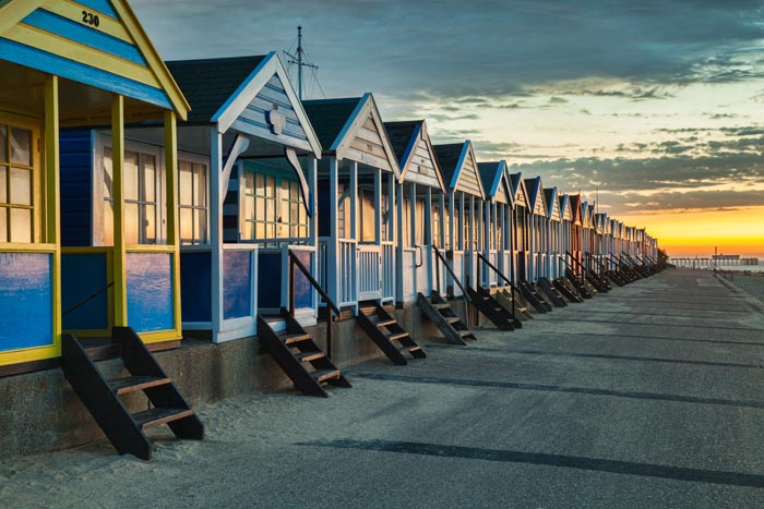 Beach huts at Southwold, Suffolk, England, at sunrise.