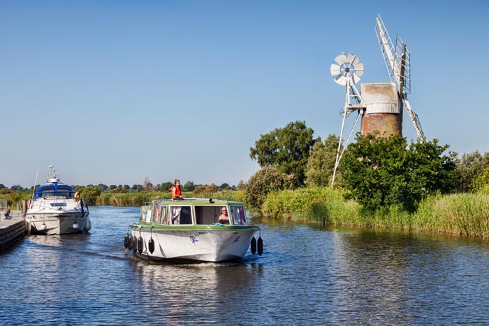 Motor cruisers near Turf Fen Windmill on the Norfolk Broads, Norfolk, England