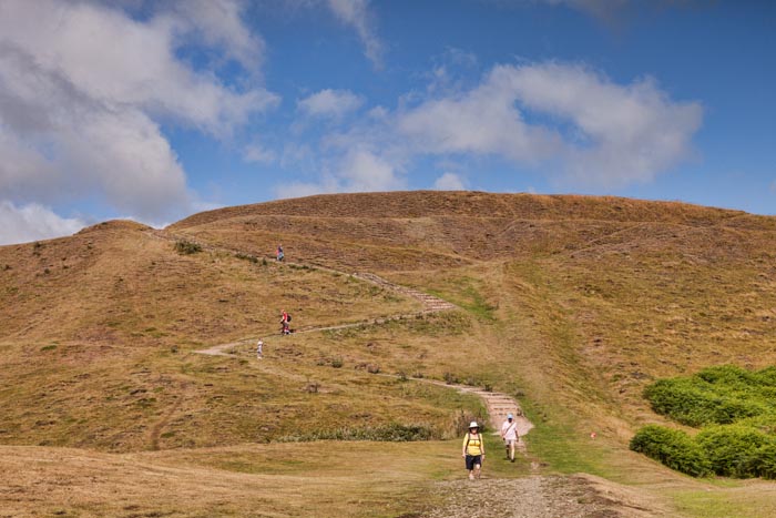 Hikers walking down from Millenium Hill, Malvern Hills, Herefordshire and Worcestershire, England