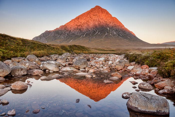 Autumn sunrise at Buachaille Etive Mor, perfectly reflected in the Coupall River, Glencoe, Lochaber, Highlands, Scotland, UK.
