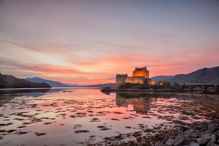 Eilean Donan Castle illuminated at twilight, Highland, Scotland, UK