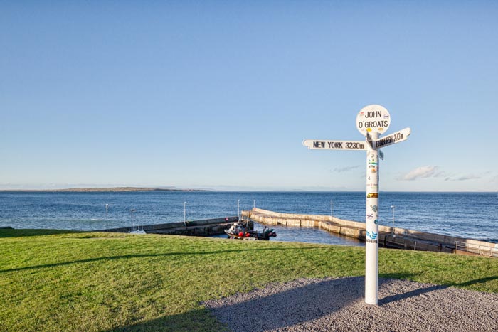 Signpost at John o' Groats, the furthest north-east inhabited point of mainland Britain.