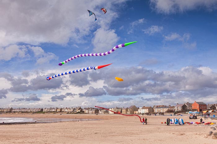 Flying inflatable kites at Newbiggin by the Sea, Northumberland, England, UK