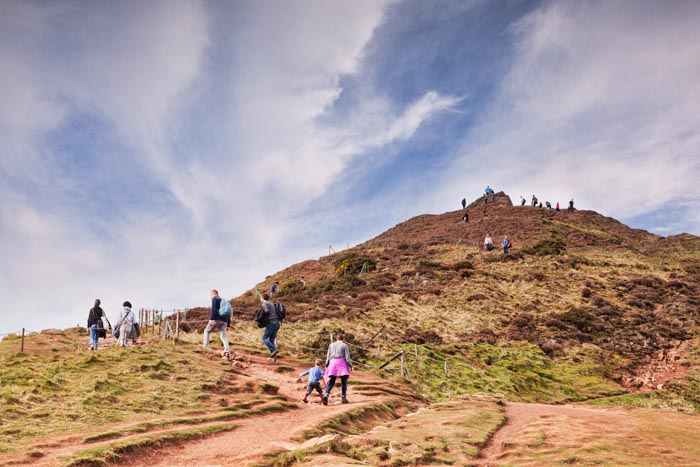 Hikers walking to the top of Arthur's Seat, Edinburgh, Scotland, UK