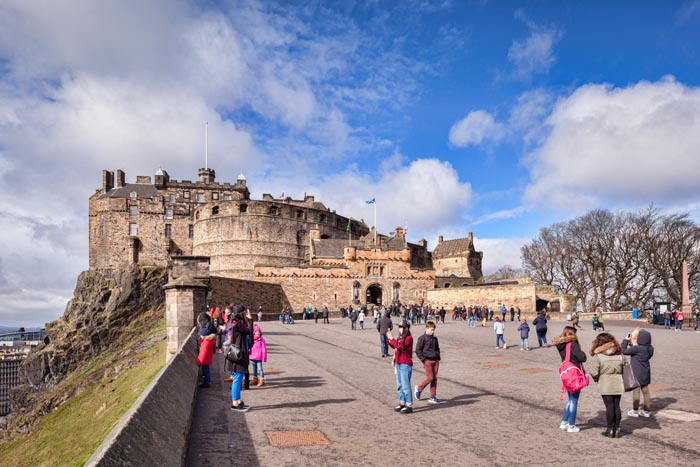 Tourists in the forecourt of Edinburgh Castle on a bright Spring day, Edinburgh, East Lothian, Scotland, UK