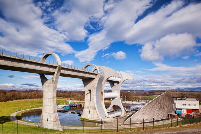 The high level approach to the Falkirk Wheel, the rotating boat lift connecting the Forth and Clyde Canal with the Union Canal, on a sunny spring day, Falkirk, Scotland, UK