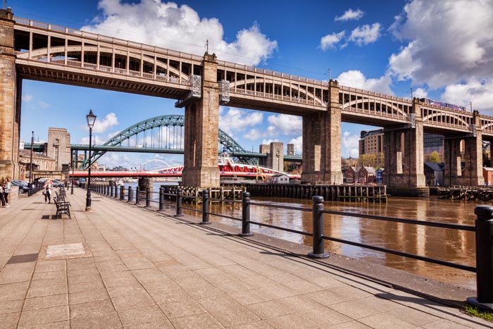 Railway Viaduct, known as the High Level Bridge, across the River Tyne, and a view through to the Swing Bridge, the Tyne Bridge and the Gateshead Millennium Bridge, Newcastle-upon-Tyne, England, UK