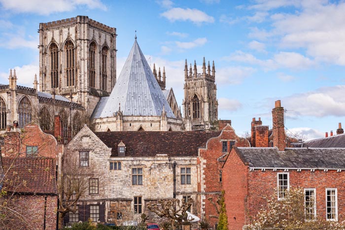 View over roof tops to York Minster, from the city walls, York, North Yorkshire, England, UK