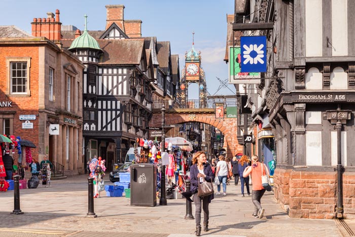 Street market in Foregate Street, with the Eastgate Clock, Chester, Cheshire, England, UK