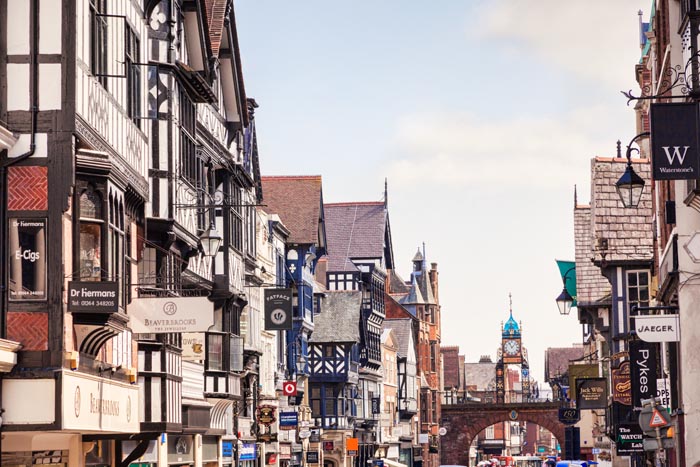 A view of Chester down busy Eastgae Street, with the Rows and the Eastgate Clock, Cheshire, England, UK