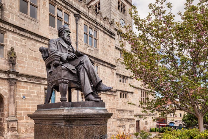 Bronze statue of naturalist Charles Darwin outside the school he attended, now a library, in Shrewsbury, Shropshire, England.