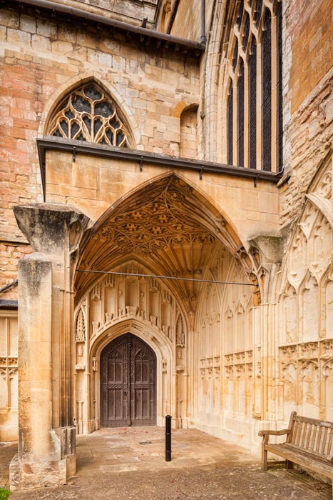 The south door and porch of the Abbey Church of St Mary the Virgin, Tewkesbury, Gloucestershire, England.