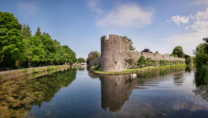 Panorama of the outer walls and moat of the Bishop's Palace in Wells, Somerset,England, UK.