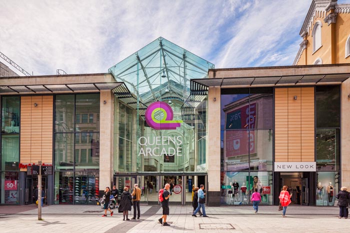 27 June 2016: Cardfiff, Wales, UK - Shoppers at the entrance to Queens Arcade, Queen Street, Cardiff, Wales.