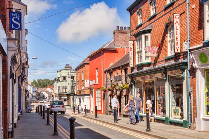 Family shopping in Cardigan High Street, Cardiganshire, Wales, UK