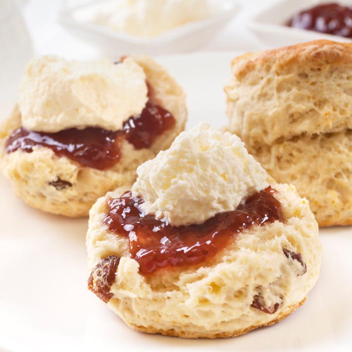 Fresh homemade fruit scones with jam and cream.