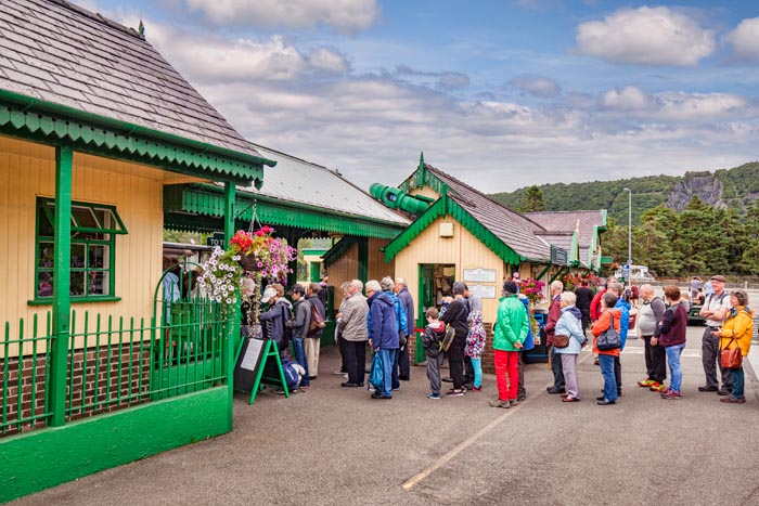 Queue of people in outdoor gear at Llanberis Station, waiting for the Snowdon Mountain Railway, Llanberis, Snowdonia National Park, Gwynedd, Wales, UK