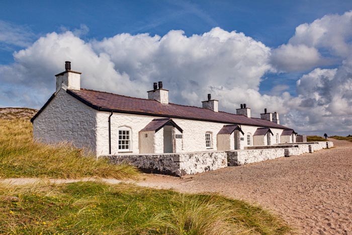 Old cottages on Llanddwyn Island, including the Pilot's Cottage Museum, Newborough, Anglesey, Wales, UK