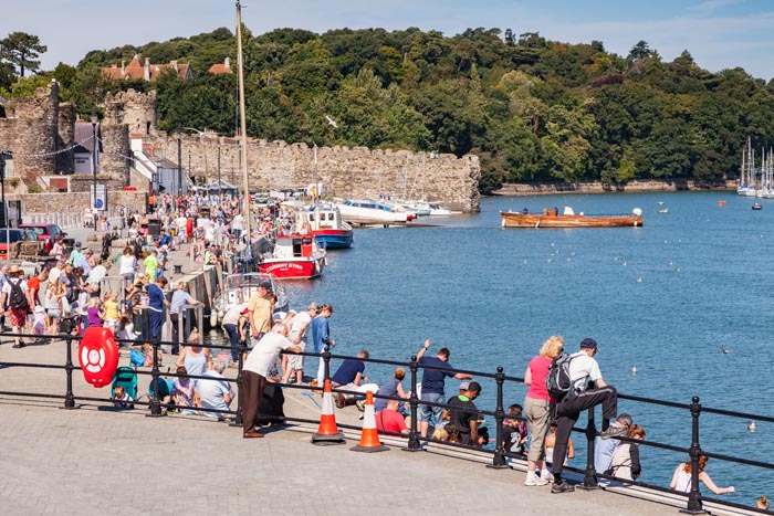 Conwy, North Wales, UK: 17 August 2016 - Crowds on the medieval quay at Conwy enjoy the continuing warm weather.