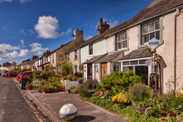 Row of cottages with lovely summer gardens in Main Street, Ravenglass, Cumbria, England, UK