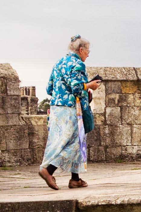Senior woman walkin along York City Walls, North Yorkshire, England, UK